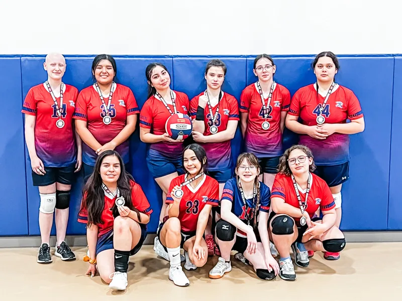 The NECA girls volleyball team standing together in uniform after a tournament.