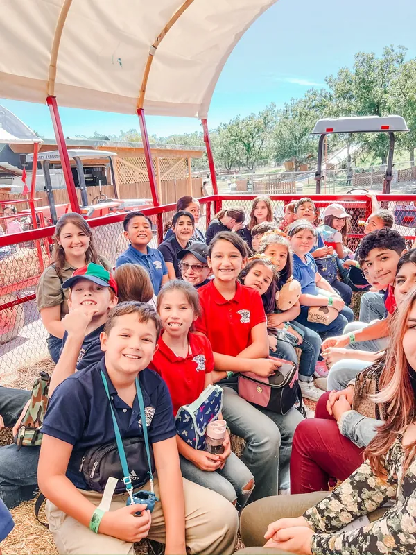 A NECA class and teacher riding together during an off-campus field trip.
