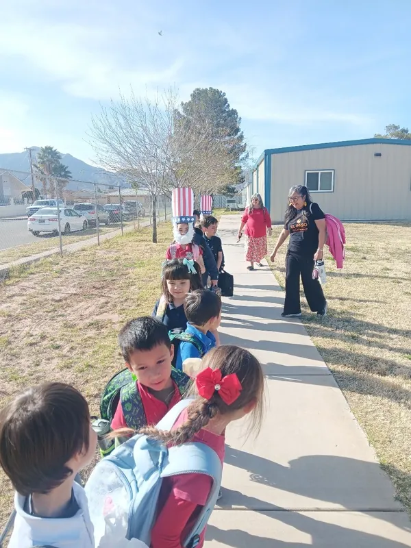 NECA students walking together along a campus sidewalk between classes.